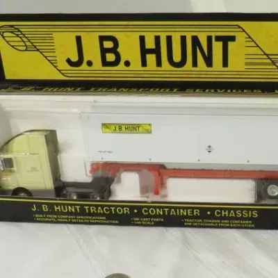 Vintage J.B. Hunt tractor, container, and chassis die-cast toy semi-truck set, new in its original packaging.