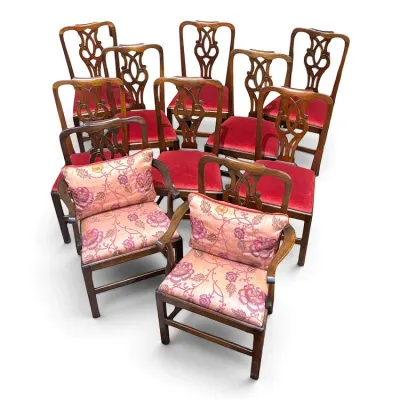 Sale Photo Thumbnail #109: Set of ten Chippendale-style mahogany dining chairs, including eight side chairs with red velvet seats and two armchairs upholstered in a pink floral fabric.