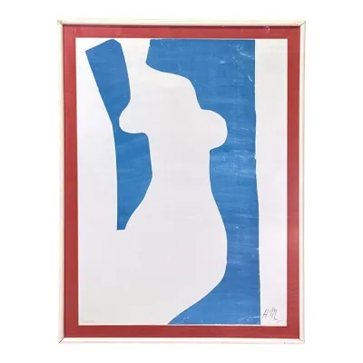 Sale Photo Thumbnail #39: Framed abstract print in the style of Henri Matisse's cut-outs, featuring a white silhouette against a blue background with a red border, signed "H.M." in the lower right.