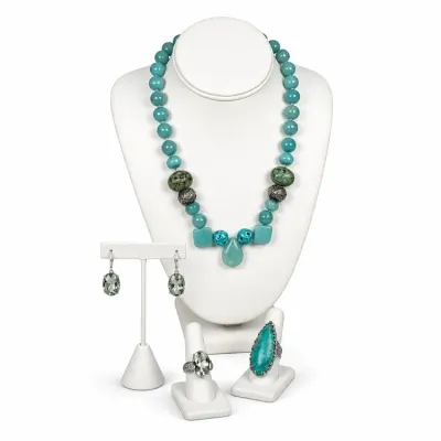 Sale Photo Thumbnail #8: Beaded turquoise-colored statement necklace, a pair of green gemstone drop earrings, and two coordinating rings displayed on white jewelry stands.
