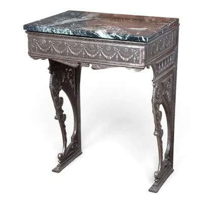 Sale Photo Thumbnail #100: Antique cast iron console table featuring a dark green and reddish-brown marble top, ornate swags on the apron, and scrollwork legs.