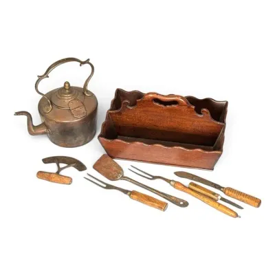 Sale Photo Thumbnail #220: Collection of antique kitchenware including a copper tea kettle, a wooden cutlery caddy, a mincing knife, and various wooden-handled utensils.