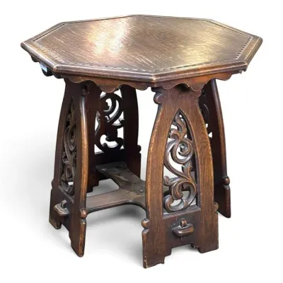 Sale Photo Thumbnail #125: Antique Gothic Revival oak side table featuring an octagonal top, scalloped apron, and four legs with ornate openwork scroll carvings.
