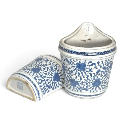 Sale Photo Thumbnail #214: Pair of Chinese blue and white porcelain wall pockets featuring an intricate floral vine motif, with one showing the bottom maker's mark.