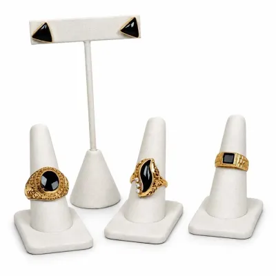 Sale Photo Thumbnail #6: Collection of 14K-18K gold jewelry featuring black stones, including a pair of triangular stud earrings and three distinct rings displayed on white stands.