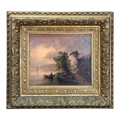 Sale Photo Thumbnail #68: Antique oil painting depicting a river landscape with a fisherman in a boat and a windmill, housed in an ornate, heavily carved giltwood frame.