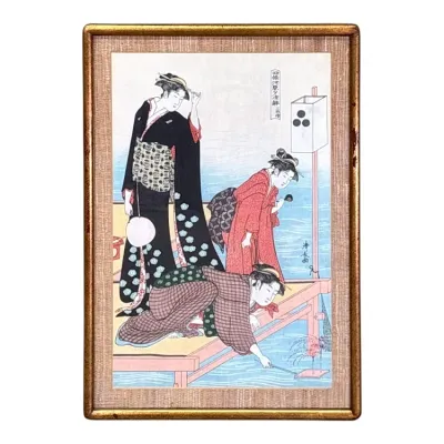 Sale Photo Thumbnail #65: Japanese ukiyo-e woodblock print depicting three women on a wooden platform by the water, presented in a gold-toned frame with a textured mat.