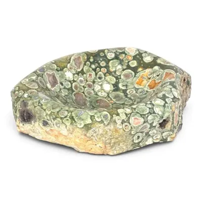 Sale Photo Thumbnail #174: Polished rhyolite or jasper stone bowl, featuring a natural green and cream orbicular pattern with a rough-hewn exterior base.