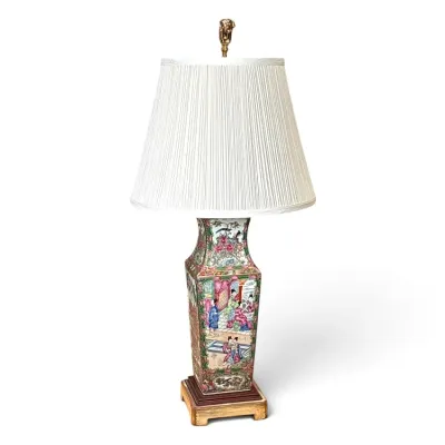 Sale Photo Thumbnail #168: Chinese Famille Rose porcelain vase lamp featuring hand-painted court scenes and floral motifs, mounted on a wooden base with a pleated white shade.