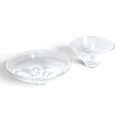 Sale Photo Thumbnail #188: Two clear art glass bowls, including a shallow dish with a molded floral pattern at the base and a deeper flared bowl.