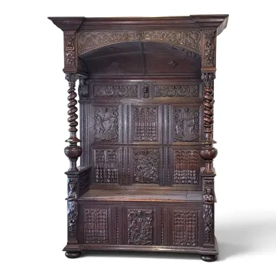 Sale Photo Thumbnail #102: Antique carved oak hall bench with a high canopy back, featuring intricate relief panels depicting biblical scenes, barley twist columns, and a lift-top storage seat.