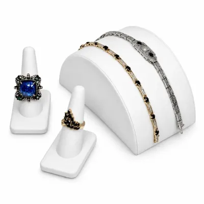 Sale Photo Thumbnail #4: Assortment of fine jewelry including an ornate blue sapphire and diamond ring, a black gemstone cluster ring, a gold and black gemstone tennis bracelet, and an Art Deco style silver-tone filigree bracelet.