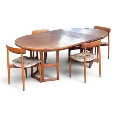 Sale Photo Thumbnail #86: Mid-century modern teak dining set featuring an oval extension table with trestle base and four matching chairs with patterned fabric seats.