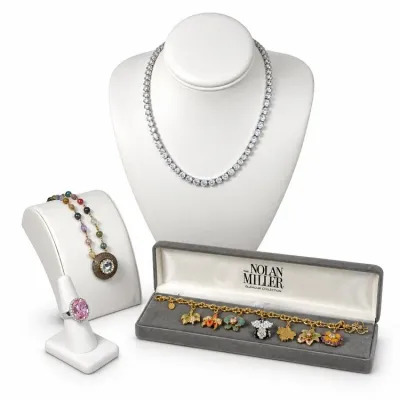 Sale Photo Thumbnail #14: Assorted fine jewelry collection, featuring a diamond-style tennis necklace, a multi-colored gemstone pendant necklace, a pink gemstone ring, and a Nolan Miller floral charm bracelet in its original box.