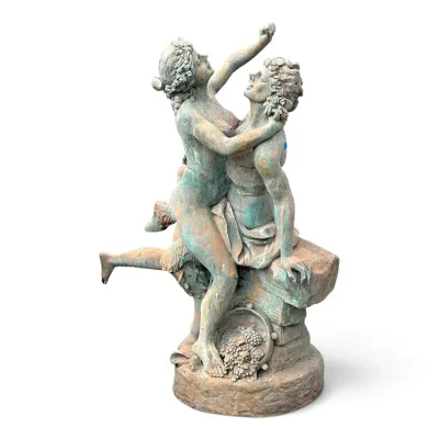 Sale Photo Thumbnail #239: Classical-style garden statue depicting a romantic couple, featuring a weathered verdigris and terracotta finish with a grape basket detail at the base.