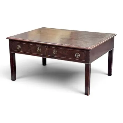 Sale Photo Thumbnail #115: Antique mahogany library table or writing desk featuring a leather-inlaid top, two drawers with brass ring pulls, and straight square legs.