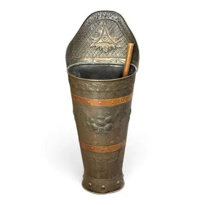 Sale Photo Thumbnail #225: Antique embossed brass and copper umbrella stand featuring a high back with a central starburst motif and floral details.