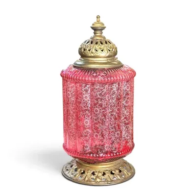 Sale Photo Thumbnail #163: Vintage Hollywood Regency style pink glass table lamp featuring a textured floral pattern, set on an ornate brass base with a matching brass cap.