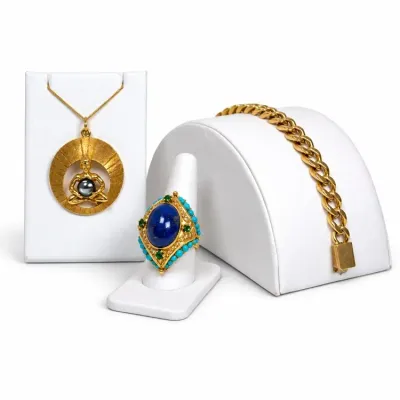 Sale Photo Thumbnail #15: Collection of fine gold jewelry including a Buddha pendant with a dark pearl, a lapis lazuli ring accented with turquoise and emeralds, and a classic curb link bracelet.