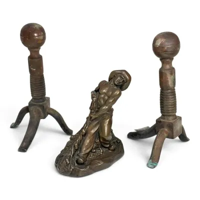 Sale Photo Thumbnail #181: Vintage cast bronze or brass fireplace set featuring a central figure of a laborer and two matching ball-top andirons with ribbed columns and tripod bases.