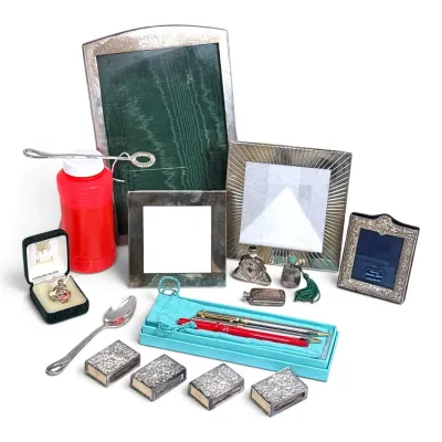 Sale Photo Thumbnail #131: Collection of vintage sterling silver and decorative items, including picture frames, a Tiffany & Co. pen set, matchbox covers, a spoon, and small perfume bottles.