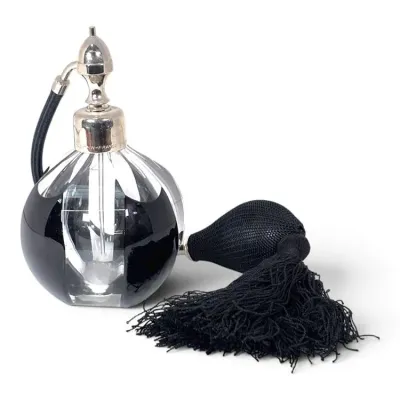 Sale Photo Thumbnail #177: Vintage French crystal perfume bottle featuring a black and clear glass body, silver-tone hardware, and a black mesh squeeze bulb with a long tassel.
