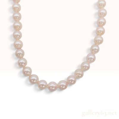 Sale Photo Thumbnail #212: A Graduated Cultured Pearl Necklace with a Rosette Motif Silver Clasp
