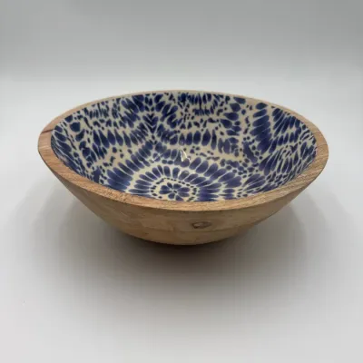 Sale Photo Thumbnail #71: Handcrafted wooden bowl featuring a natural exterior and a glossy, blue and white patterned enamel interior.