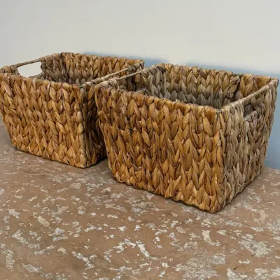 Sale Photo Thumbnail #141: Pair of rectangular woven water hyacinth storage baskets with integrated handles, in good used condition.