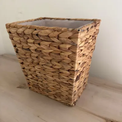 Sale Photo Thumbnail #142: Square woven water hyacinth wastebasket or storage bin with a tapered design, showing light wear.