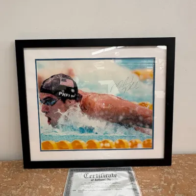 Sale Photo Thumbnail #102: Framed and matted autographed photo of Olympic swimmer Michael Phelps, accompanied by a Certificate of Authenticity from Grandstand Sports.