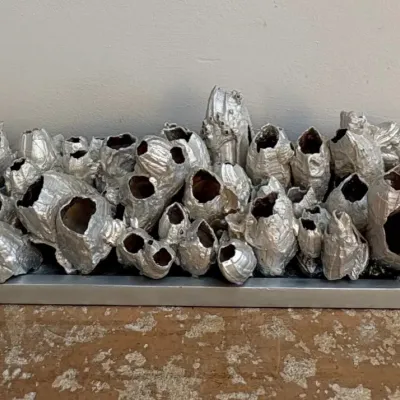 Sale Photo Thumbnail #92: Contemporary silver-painted barnacle cluster sculpture mounted on a matching rectangular base.