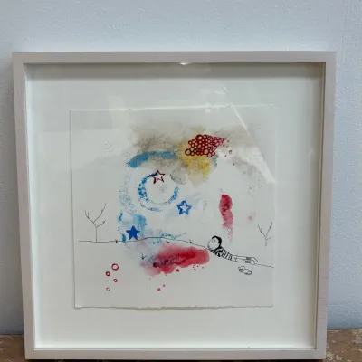Sale Photo Thumbnail #96: Whimsical mixed-media artwork featuring a hand-drawn figure and abstract watercolor elements, presented in a square white frame with a wide mat.