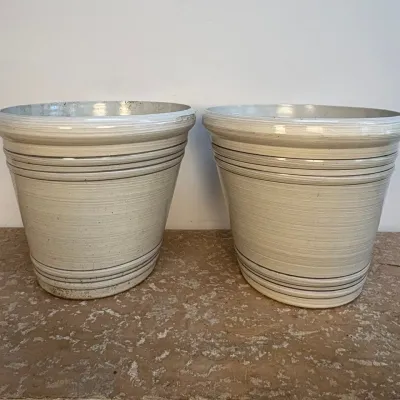 Sale Photo Thumbnail #175: Pair of vintage off-white  planters featuring horizontal ribbed detailing and a subtle textured glaze.