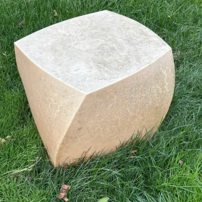 Sale Photo Thumbnail #12: Modernist cast stone garden stool or pedestal with a twisted cube design, showing natural weathering from outdoor use.