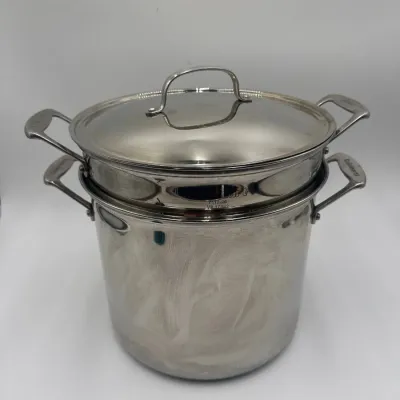 Sale Photo Thumbnail #65: Cuisinart stainless steel stockpot with a steamer insert and matching lid, showing light surface wear.