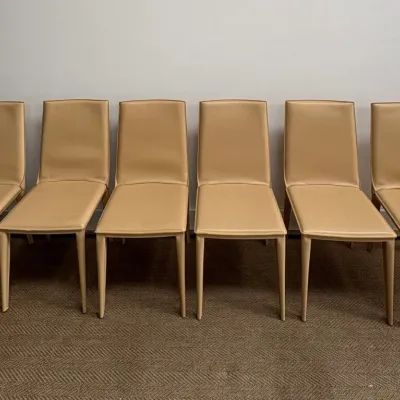 Sale Photo Thumbnail #33: Set of six modern minimalist dining chairs upholstered in beige leather with matching leather-wrapped legs.
