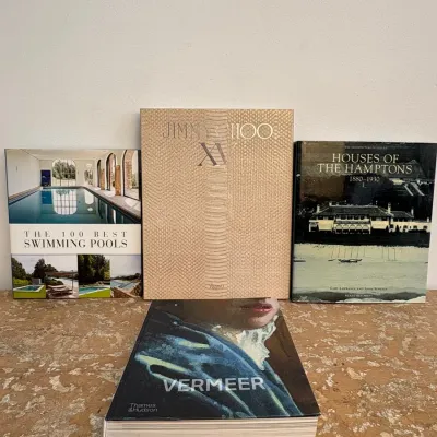 Sale Photo Thumbnail #89: Collection of four hardcover coffee table books, including "Vermeer" by Thames & Hudson, "Jimmy Choo XV" by Rizzoli, "The 100 Best Swimming Pools," and "Houses of the Hamptons 1880-1930."