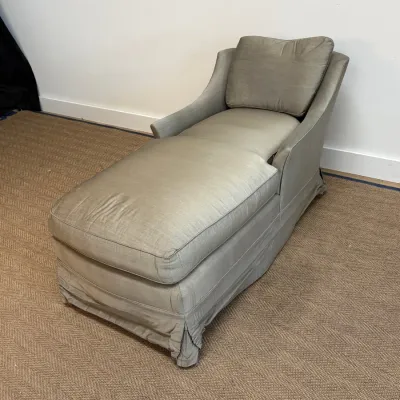 Sale Photo Thumbnail #29: Upholstered chaise lounge in a muted sage green fabric, featuring a skirted base and a matching back cushion.