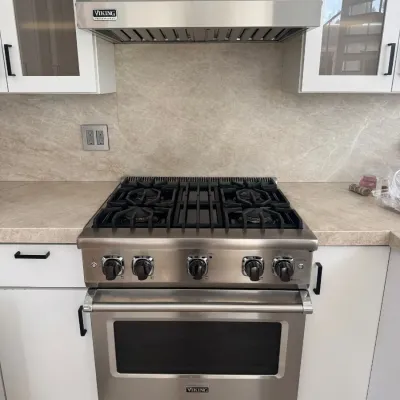 Sale Photo Thumbnail #13: Viking Professional stainless steel gas range and matching range hood, featuring heavy-duty cast iron grates and front-control knobs.