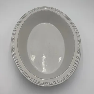 Sale Photo Thumbnail #74: Vintage white ceramic oval serving bowl featuring a beaded rim with a grey-washed finish.