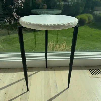 Sale Photo Thumbnail #23: Contemporary three-legged accent table featuring a round white marble top with a rough-hewn edge, supported by tapered black metal legs.