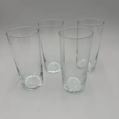Sale Photo Thumbnail #67: Set of four clear glass highball tumblers with a simple, modern design and weighted bases.