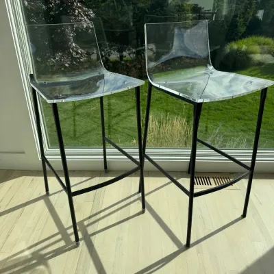 Sale Photo Thumbnail #17: Pair of modern bar stools featuring clear acrylic seats on slender black metal frames.