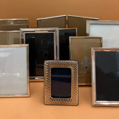 Sale Photo Thumbnail #68: Collection of vintage silver-plated and gold-toned metal picture frames in various sizes, featuring beaded borders and textured finishes.