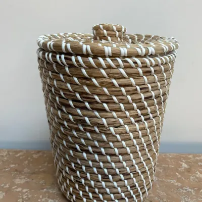 Sale Photo Thumbnail #139: Coiled seagrass lidded basket woven with white plastic accents, featuring a matching knob on the lid.