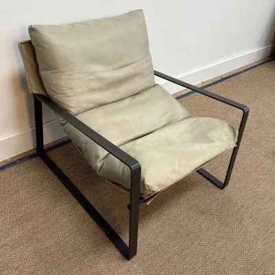 Sale Photo Thumbnail #28: Modernist lounge chair featuring a black metal frame and light olive green leather cushions.