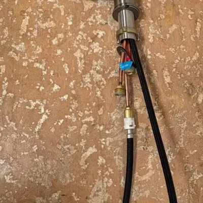 Sale Photo Thumbnail #156: Modern single-handle kitchen faucet with a brushed nickel finish and high-arc gooseneck spout, complete with attached supply lines.