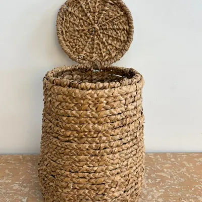 Sale Photo Thumbnail #57: Hand-woven seagrass or water hyacinth storage basket with an attached hinged lid, featuring a chunky braided texture.