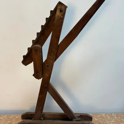 Sale Photo Thumbnail #162: Antique wooden wagon jack with a notched lifting arm and lever, showing a dark, aged patina.